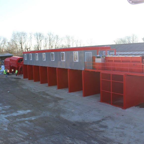 a row of storage containers with gray and red colors placed in a construction area showcasing industrial design and functionality related to storage solutions for 4 diverse uses